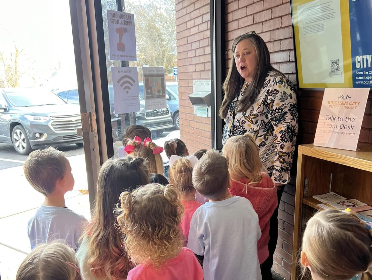 image of librarian and children on a library tour
