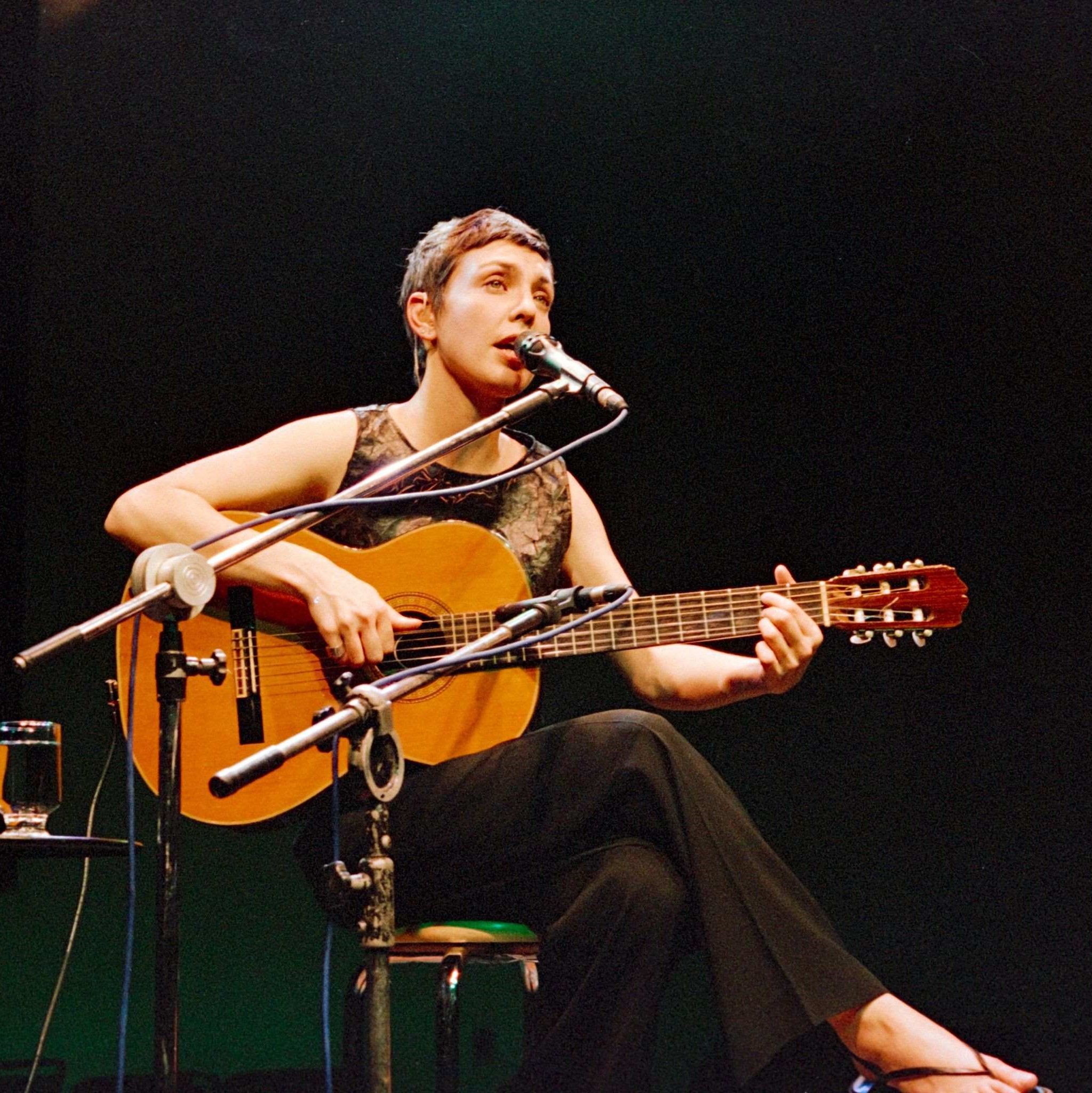 woman on stage with guitar