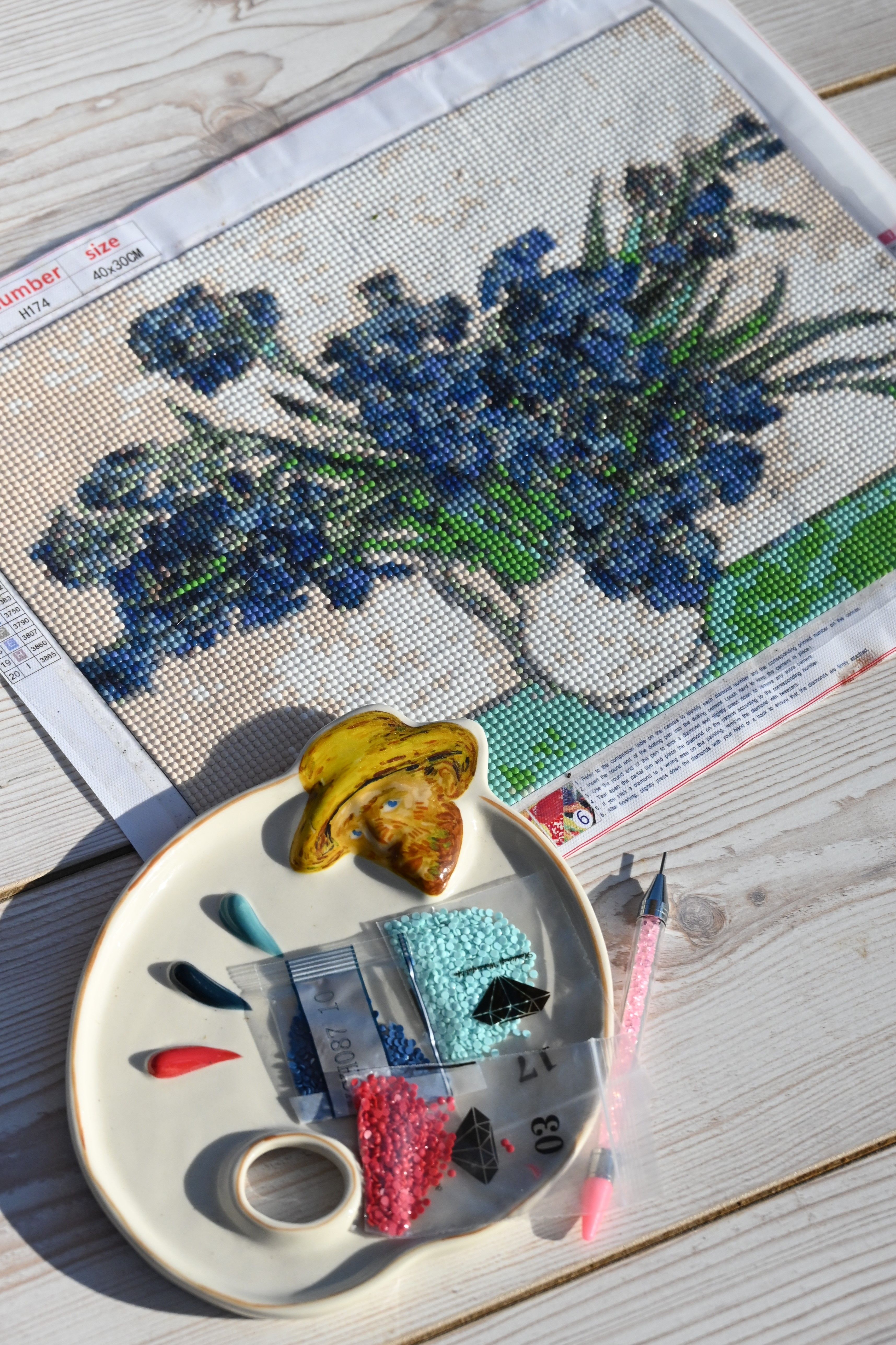 An image created by faux gemstones embroidered on paper.