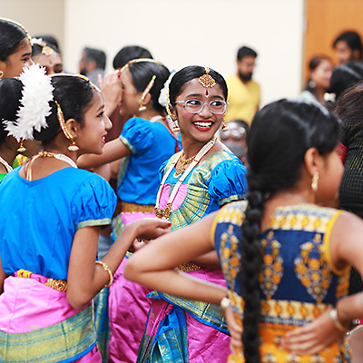 Young Diwali dance performers in a crowded Library meeting room 