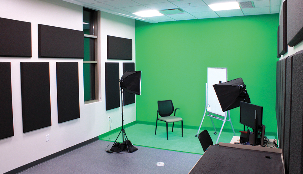Geneva Public Library's recording studio with noise dampening panels, light boxes, green screen, and computers for video and audio editing