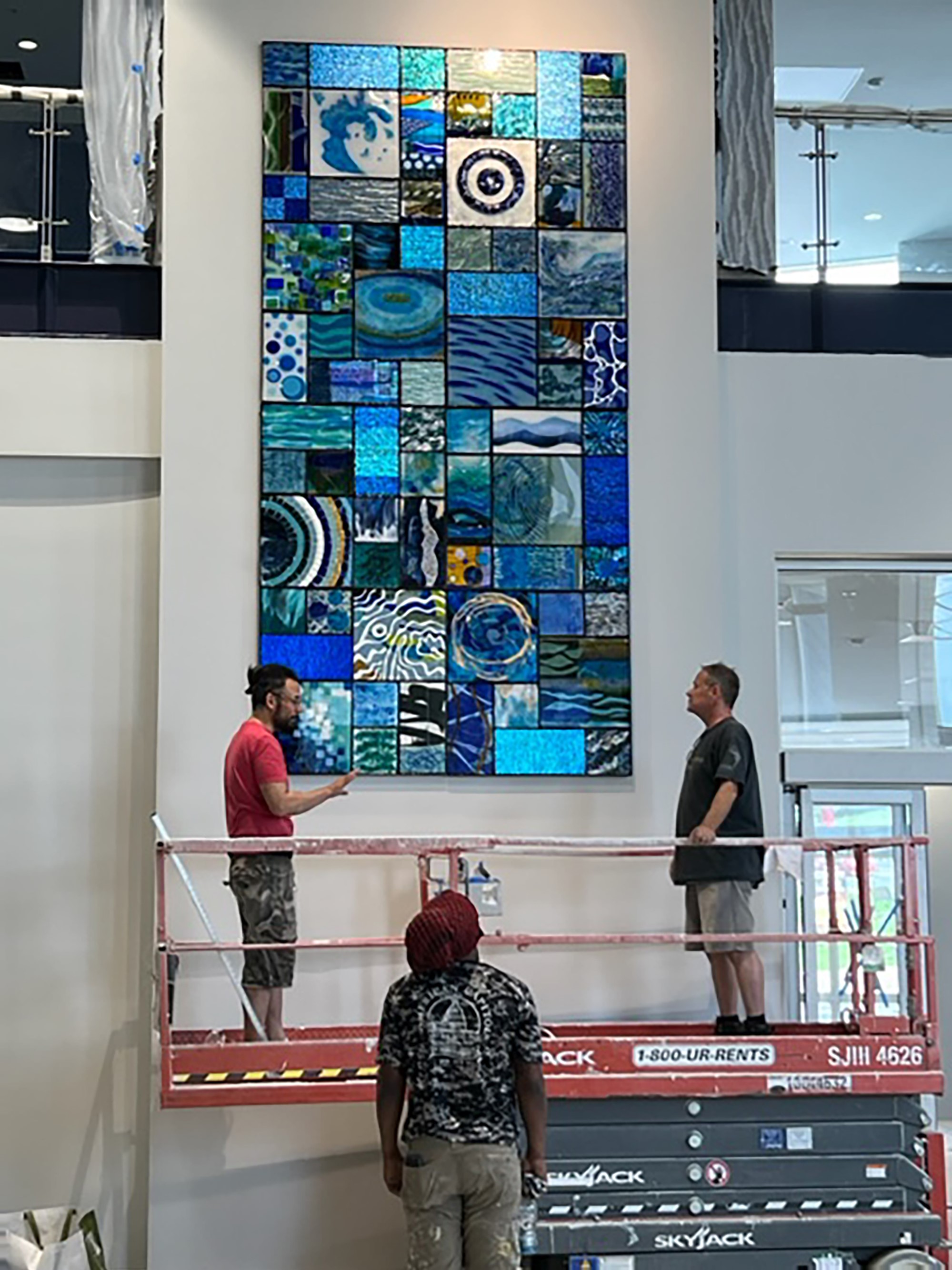 Washington Art Studio artists Michael Janis and Erwin Timmers install Art in Public Places piece at the new Bladensburg Branch.