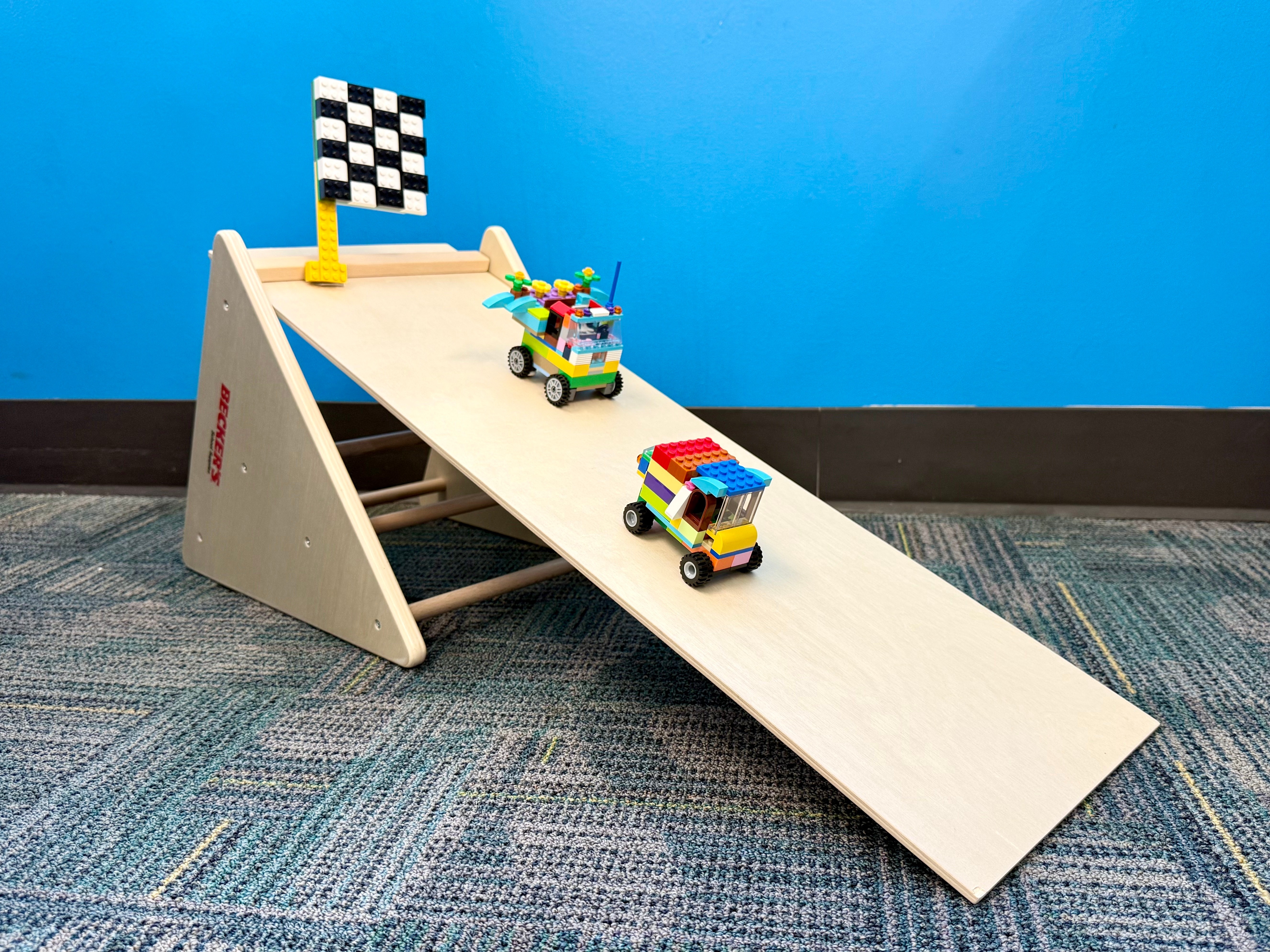 Image of Lego vehicles on a wooden ramp