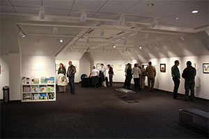 People in a large room looking at an art exhibit