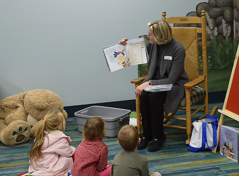 Librarian reading a story to toddlers