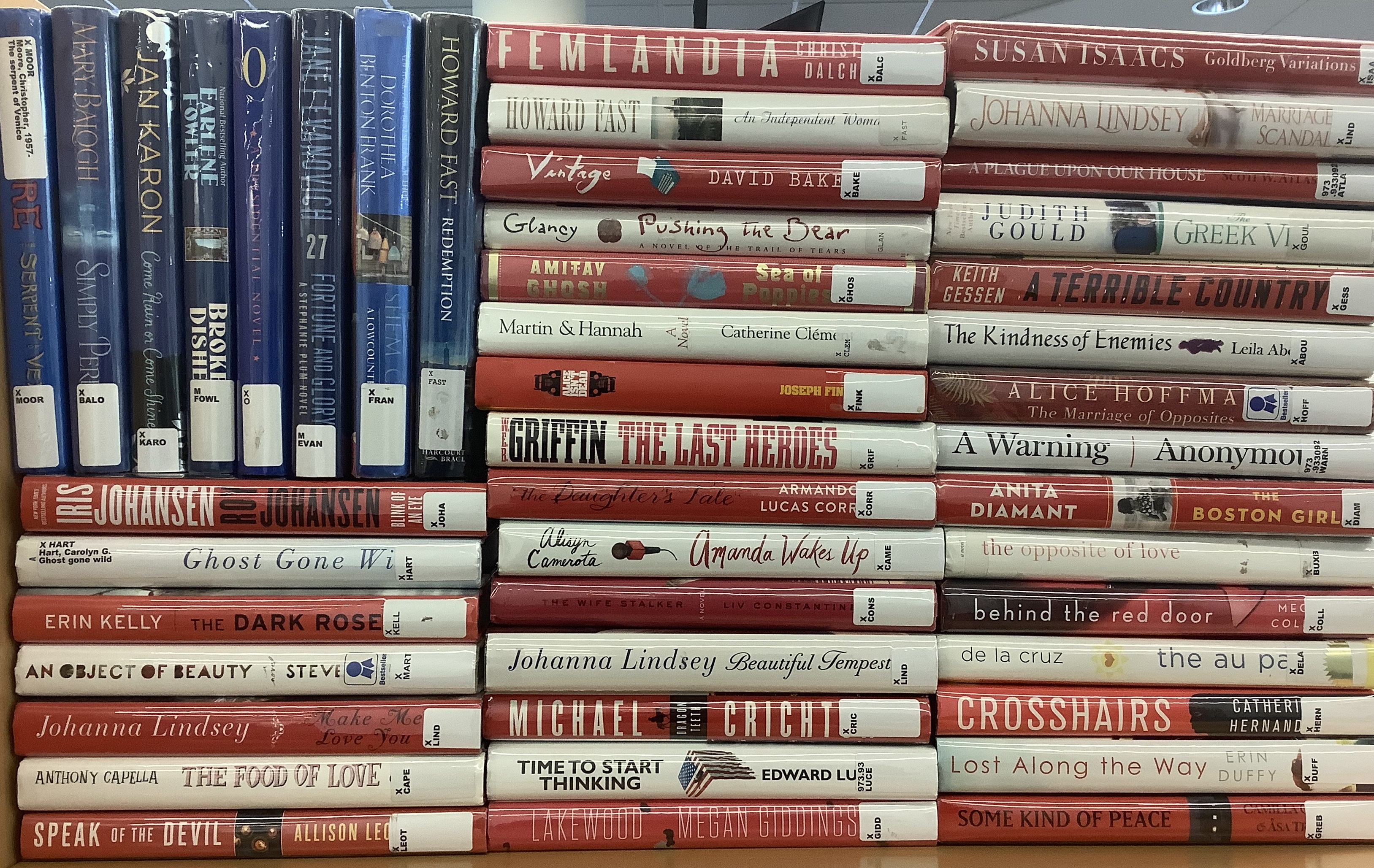 An American flag made out of red white and blue book spines
